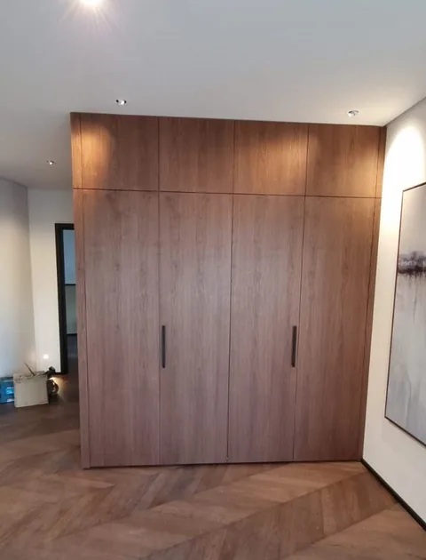 Turnkey custom furniture project in Walnut Built In Wardrobe Custom Furniture by RPGroup